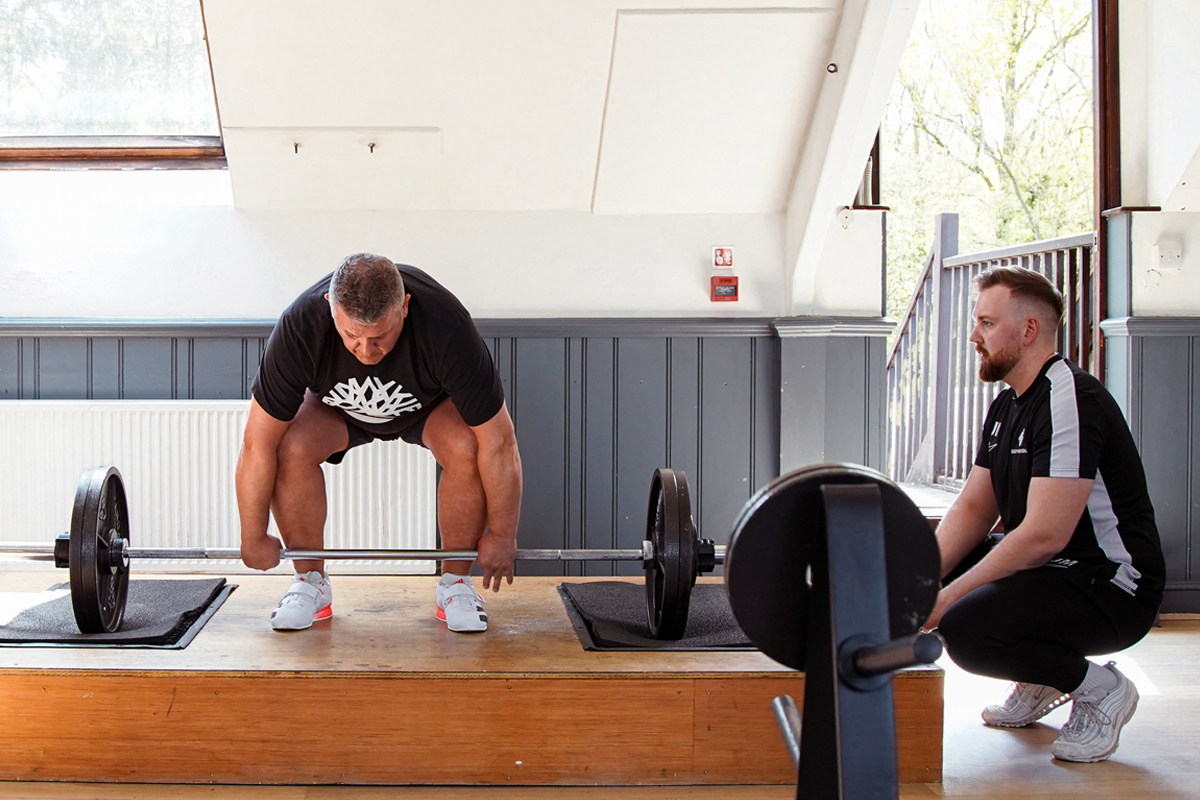 Jon coaching a client on deadlifting technique