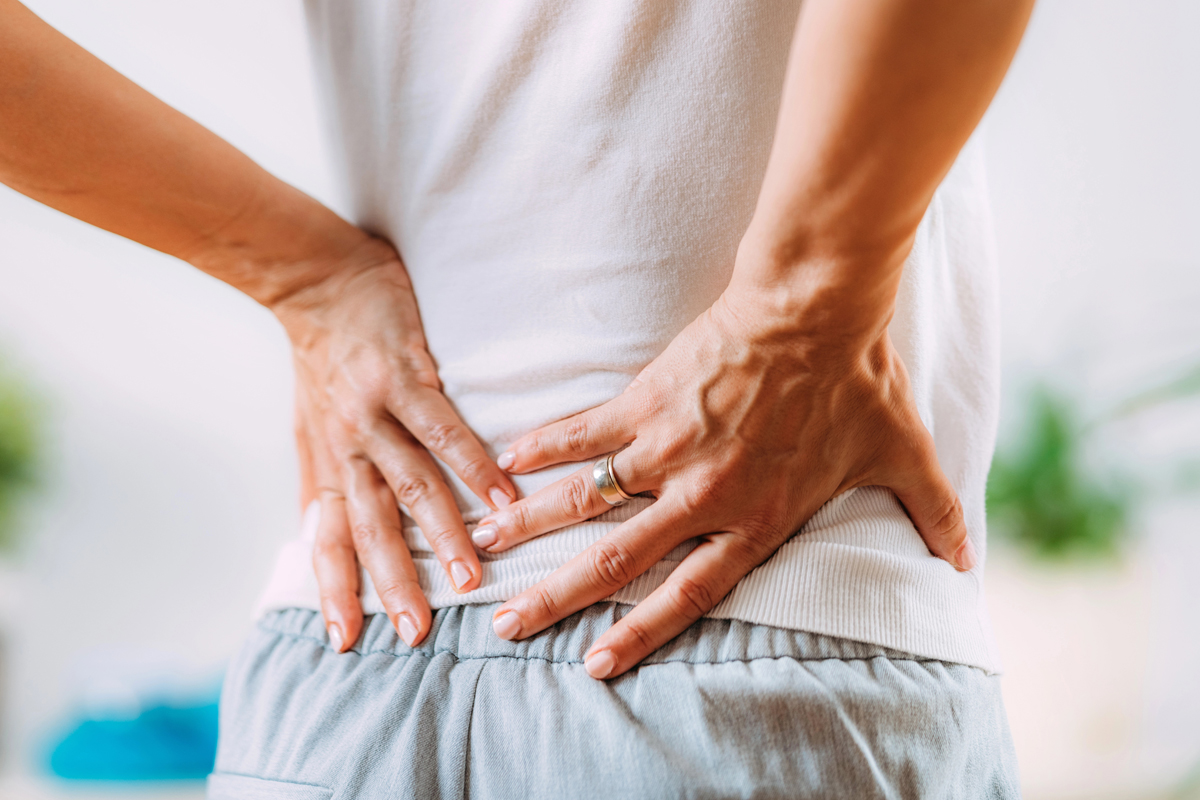 PainPoints-Sciatica Woman holding her lower back due to sciatica pain